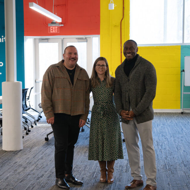 Alfonso standing with two housing leaders