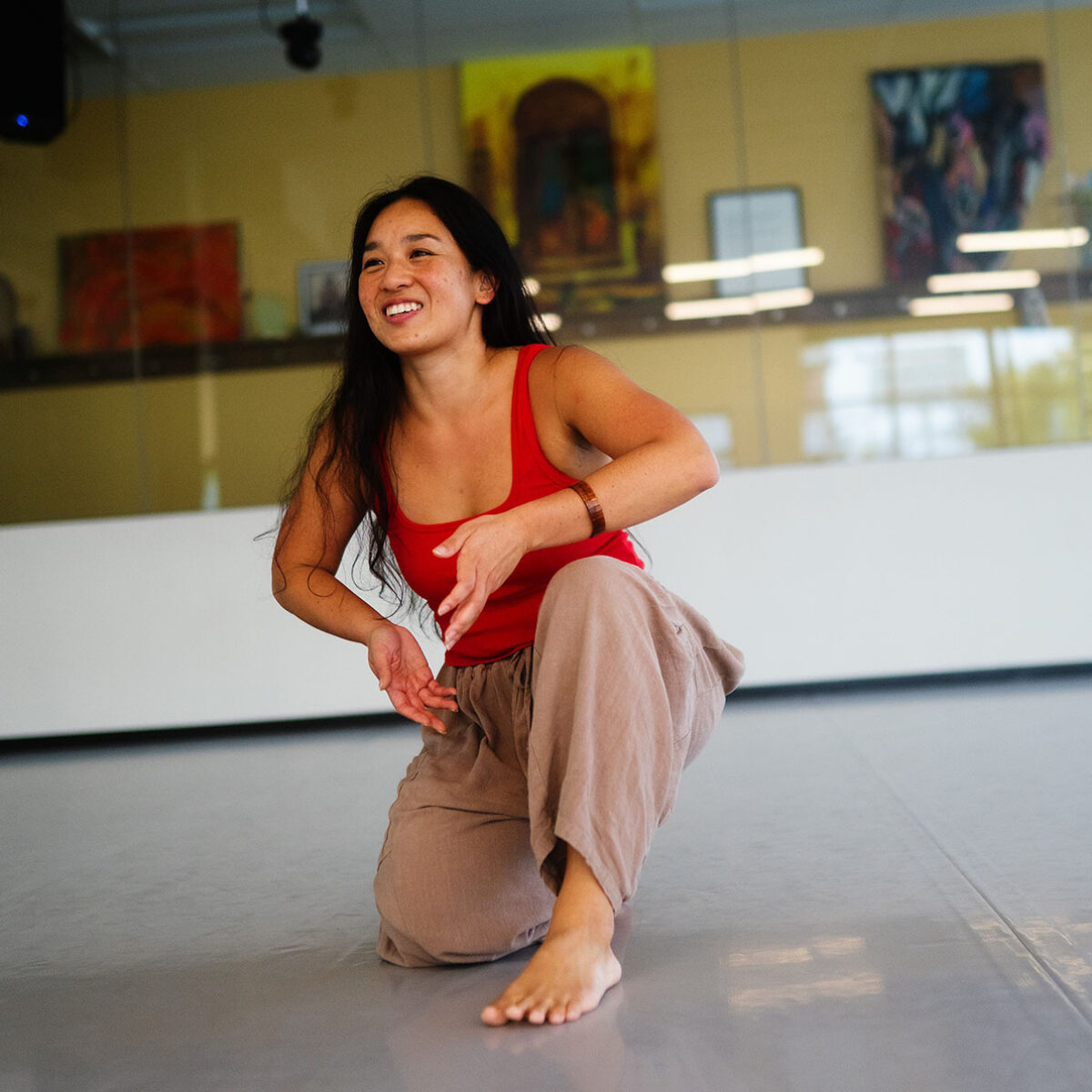 Kealoha smiling and dancing in a studio