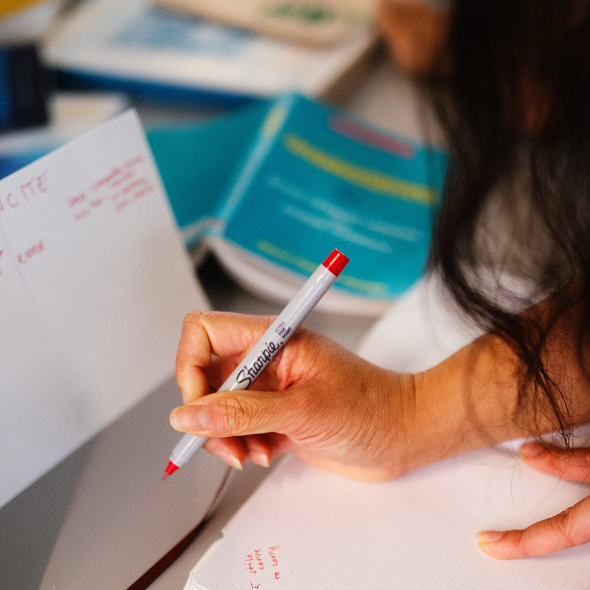 Kealoha writing with a red pen