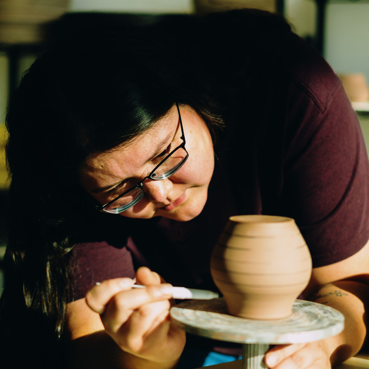 Rochelle putting detailed touches on her pottery