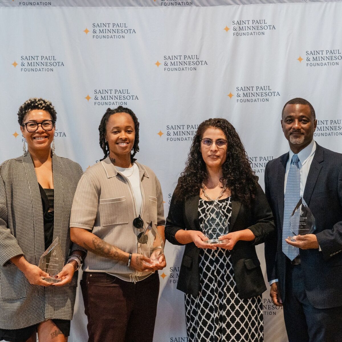 2024 Facing Race Award recipients with their awards
