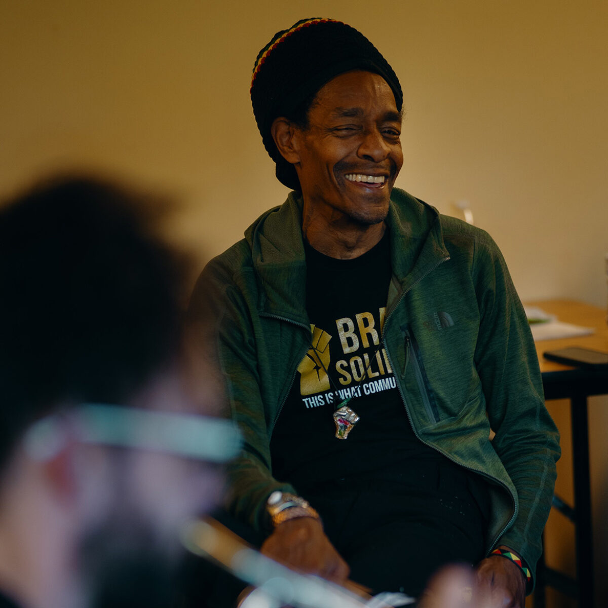Man smiling in a Brass Solidarity shirt