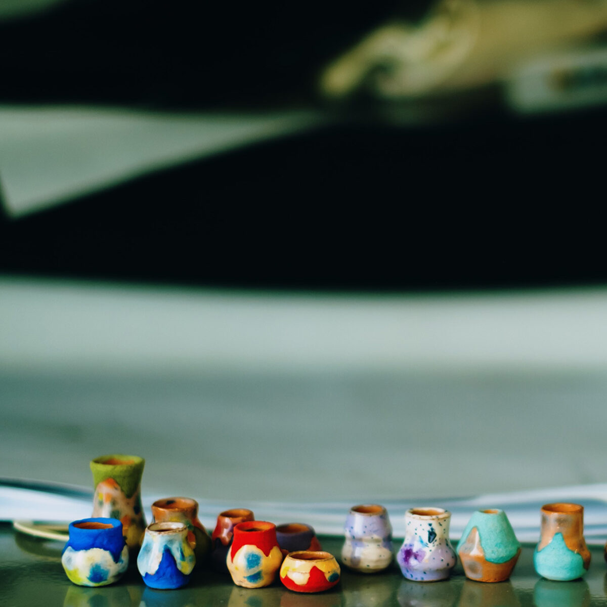 Row of several small pieces of colorful pottery
