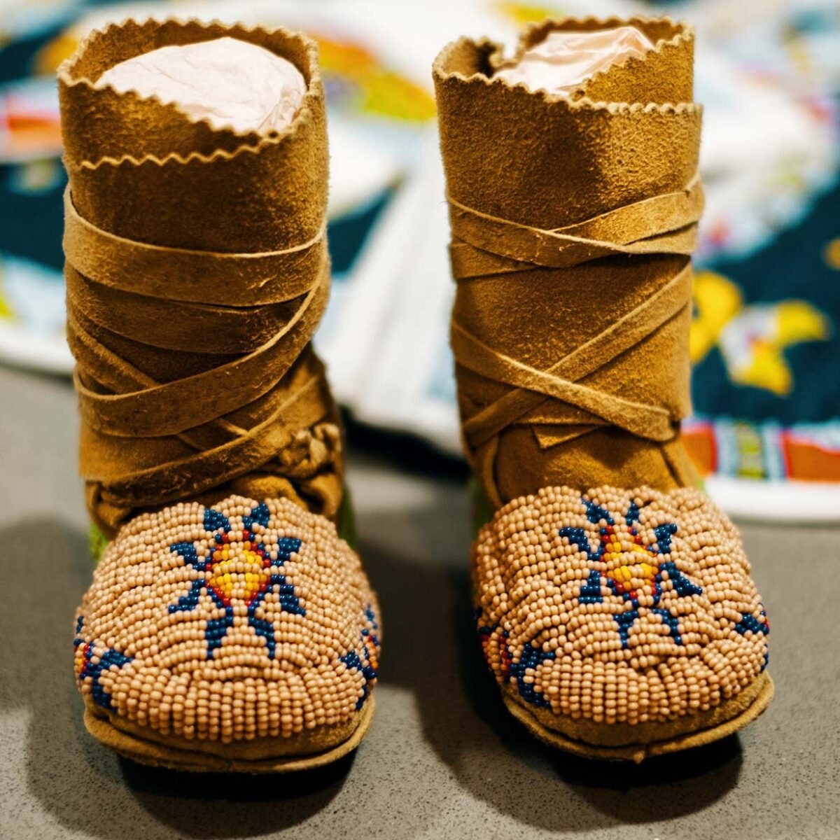 The first pair of moccasins Raine made for her daughter