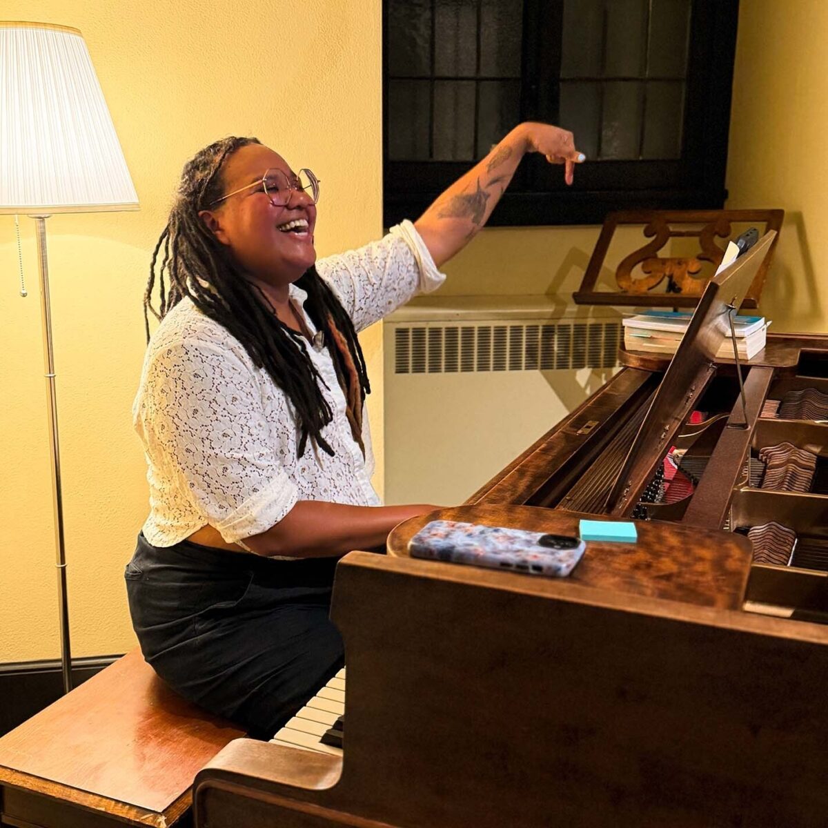 Waigwa conducting from the piano during a reheasal