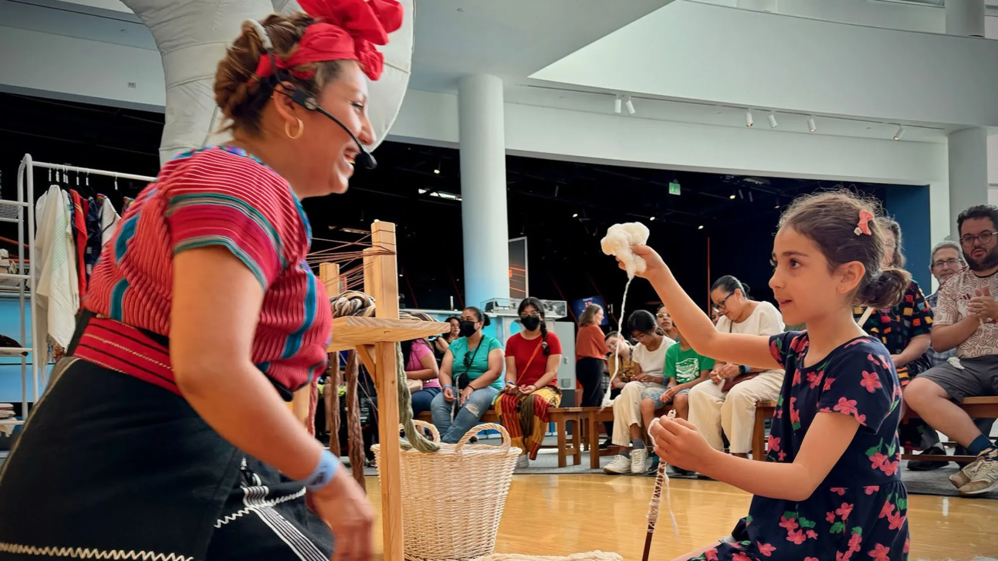 Woman with colorful outfit making art with a young child