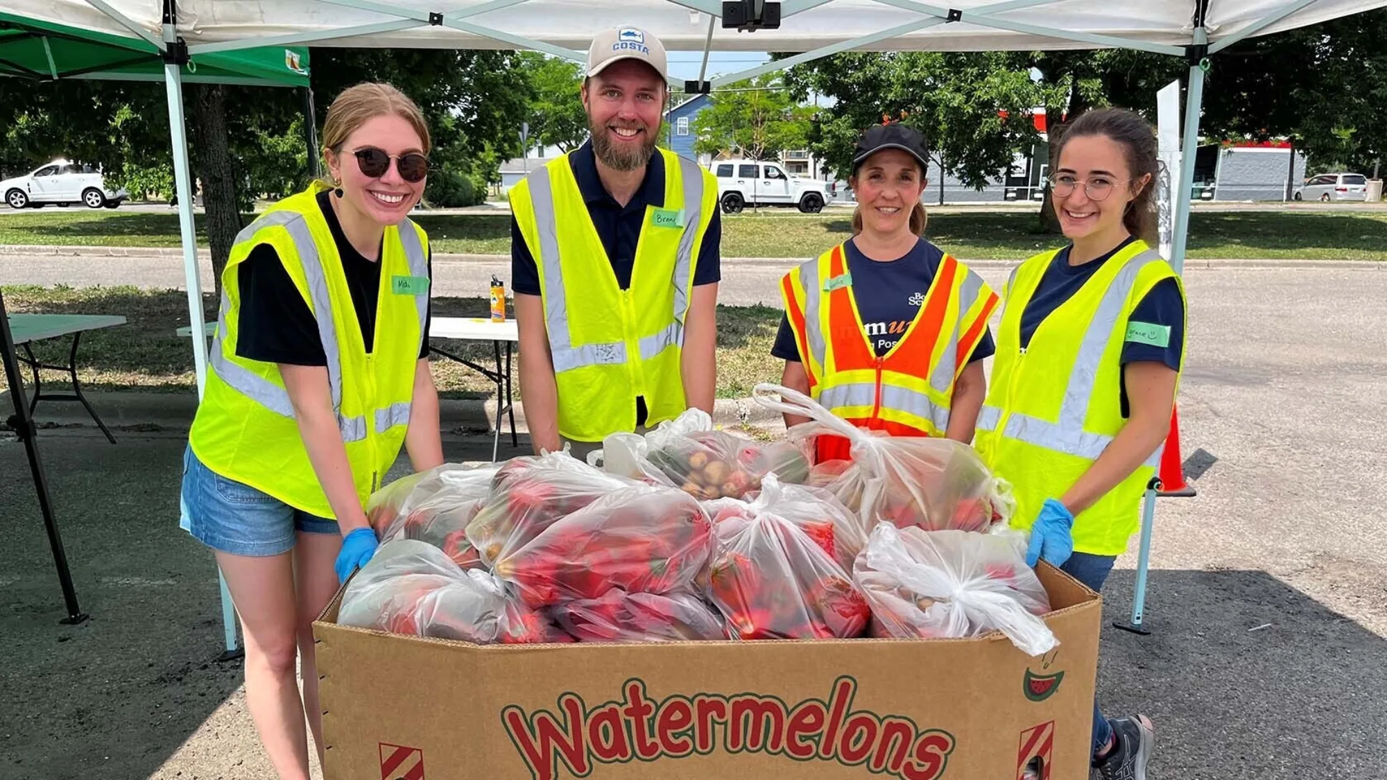 Keystone Community Services volunteers posing in front of a large box of food 16x9