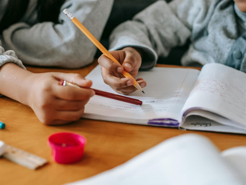 Community Solutions Teacher helping a student with his homework