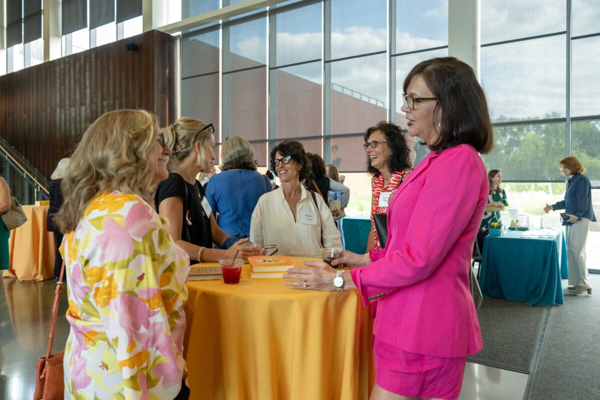 Attendees socializing around table